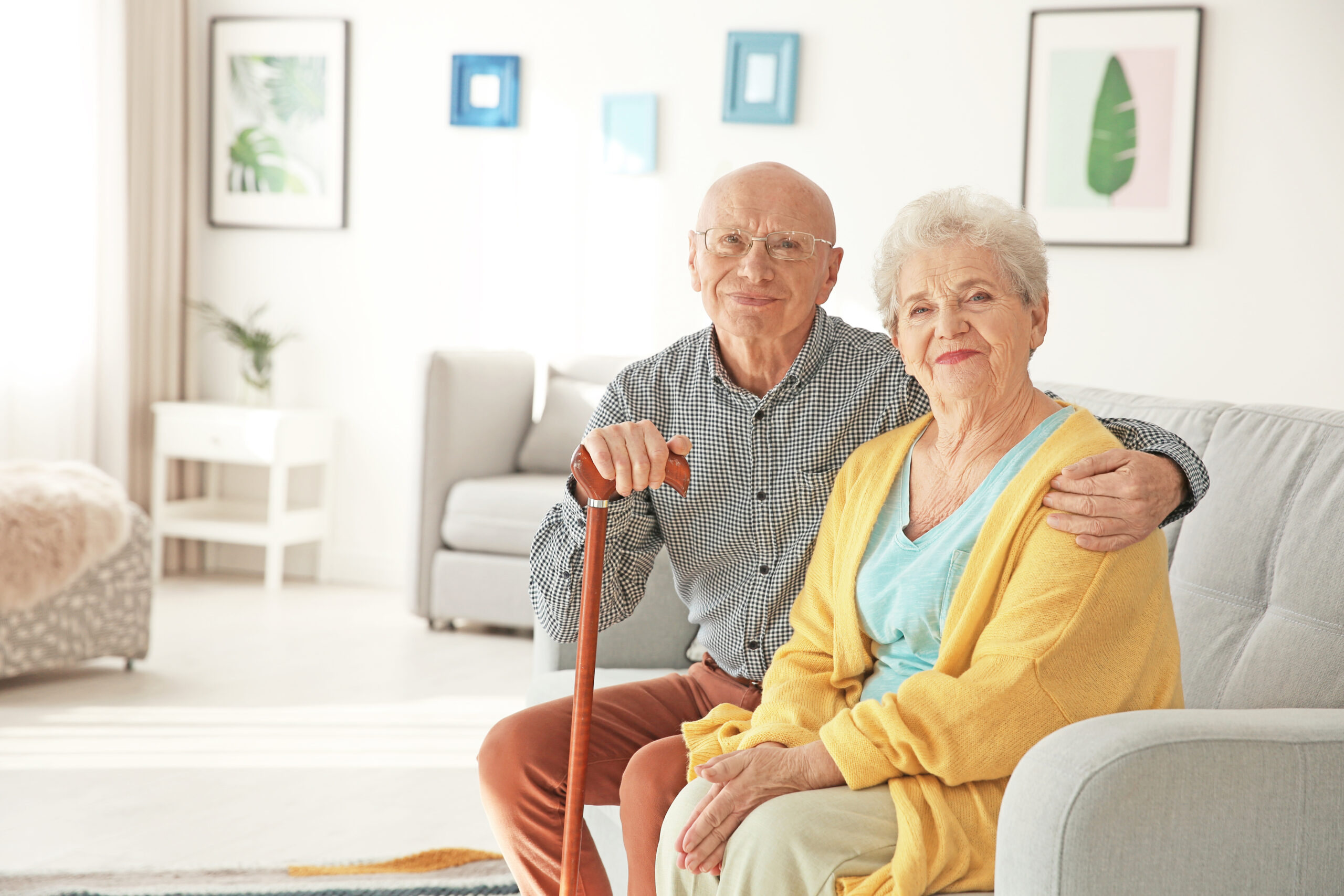 Elderly couple sitting on couch in living room